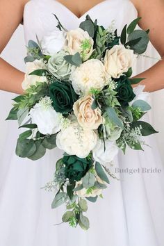 a bridal holding a bouquet of white and green flowers