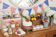 a patriotic dessert bar with strawberries, lemons, and other foods on it