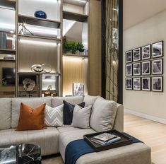 a living room filled with lots of furniture and pictures on the wall next to it