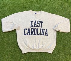 Vintage East Carolina University Sweatshirt Good Vintage Condition Made by Russell Athletic in the USA Each Vintage item is unique and fits differently. Please refer to measurements for the best fit. Size XL Width 24.5 in Length 27 in *Follow LegacyVintage on Instagram* * I ship all items in two or three business days and utilize Priority Mail options via USPS. Expedited shipping is available upon request. If you have any questions; Please Ask! * All of my items are pre-owned and, unfortunately, Unc Logo, Sweatshirts Vintage, Sweat Vintage, East Carolina University, University Crewneck, University Sweatshirts, Champion Reverse Weave, Russell Athletic, Crew Sweatshirts