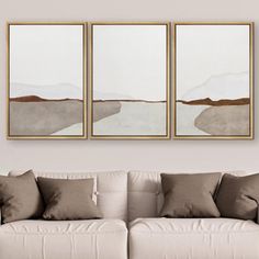 three paintings hanging on the wall above a couch in a living room with white furniture