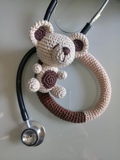 a crocheted teddy bear with a stethoscope attached to it