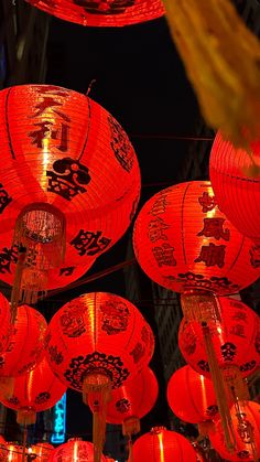 many red lanterns are hanging in the air