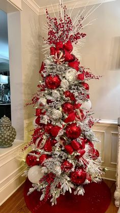 a christmas tree with red and silver decorations