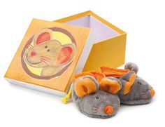 a pair of gray and orange slippers next to a box with an image of a mouse on it