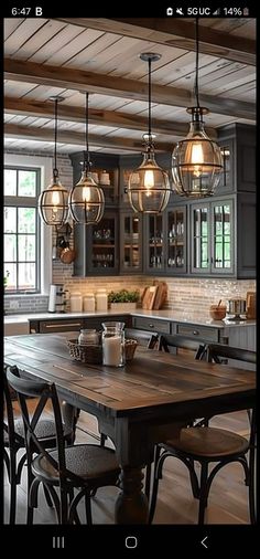 an image of a kitchen setting with lights hanging from the ceiling and chairs around the table