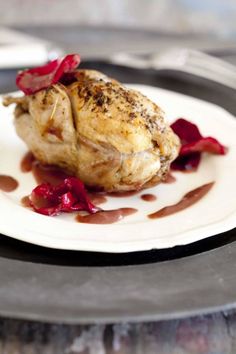 a plate with some meat on it next to a pink rose and the words making a meal of it