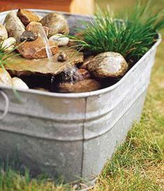 a metal bucket filled with rocks and water