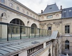 an old building with glass balconies on the roof