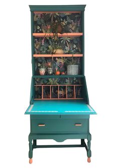 an old fashioned desk with plants on the top and bottom shelf, painted in teal green