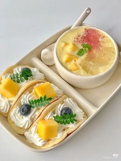 a plate with some food on it and a bowl of soup in the middle next to it