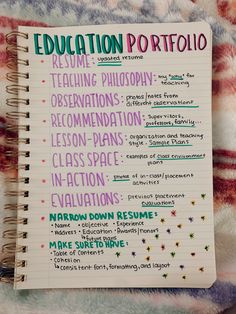 an open notebook with writing on it and the words education portfolio written in different languages