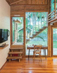 a living room filled with furniture and a flat screen tv on top of a wooden floor