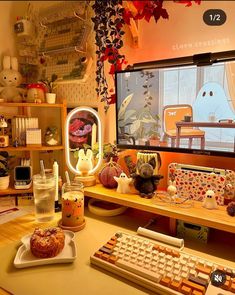 a computer desk with various items on it and a keyboard in front of the monitor