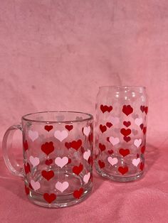 two glass mugs with hearts painted on them