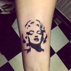 a black and white photo of a marilyn monroe tattoo