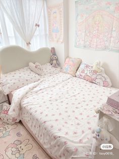 a bedroom with hello kitty bedspread and pillows