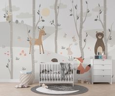 a baby's room with woodland animals and trees