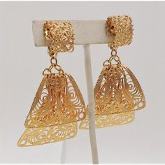 This is part of Chairish’s Costume Jewelry assortment.  1970s goldtone filigree dangle adjustable screw and clip back earrings. Marked "Napier." Measure: 2 1/5 inches long by 1 1/2 inches wide. Condition: Very good; A few tiny spots of darkening/wear.  Please reference the measurements noted in the description above for the best approximate dimensions. Please reach out to the seller under "Ask the Seller" for specific questions regarding the measurements. Brass Dangle Clip-on Earrings, Evening Metal Clip-on Chandelier Earrings, Clip-on Metal Chandelier Earrings For Evening, Antique Gold Dangle Clip-on Earrings, Vintage Gold Metal Chandelier Earrings, Antique Gold Clip-on Earrings For Party, Vintage Gold Filigree Clip-on Earrings, Gold-tone Drop Clip-on Earrings, Gold Vintage Filigree Clip-on Earrings