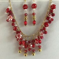 Elegant & Stylish Cherry Red Earrings and 22" inch Gold Tone Chain Necklace Jewelry Set with Glass Crystal & Metal Bead Pendants Great for any occasion. Unique Design  Main Colors:  Cherry Red Crystal Beads  Gold Tone Chain and Beads Earring Length: 4 inches longNecklace Length: 22" inches  Please review the photos carefully for they are part of the description. Thank you. Red Jewelry With Lobster Clasp For Party, Red Party Jewelry With Lobster Clasp, Holiday Beaded Dangle Jewelry, Holiday Gold Beaded Jewelry, Handmade Jewelry For Holiday Celebration, Handmade Holiday Jewelry For Celebration, Red Dangle Jewelry For Christmas, Glass Jewelry With Dangling Beads For Party, Party Jewelry With Dangling Glass Beads