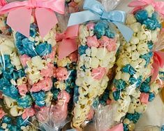 some kind of blue and pink popcorn pop with bows on it's wrappers