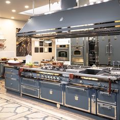 a large kitchen with an oven, stove and sink