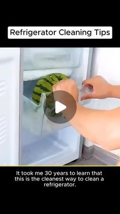 someone is cleaning the refrigerator door with a sponge