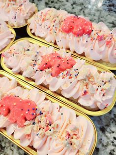 four trays filled with different types of food on top of a marble countertop