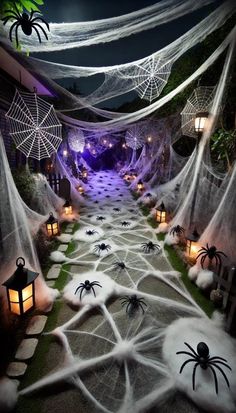 an outdoor halloween decoration with spider webs and lanterns