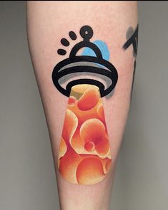 a tattoo on the leg of a person with an object in it's center