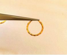 a pair of gold rings being cut with scissors