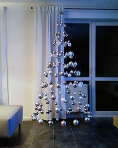 a white christmas tree sitting next to a window