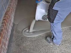 a man is using a sprayer to clean the floor