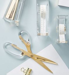 a pair of scissors and some tape on a table