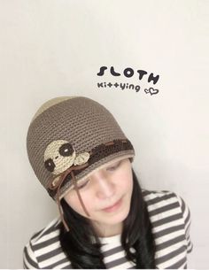 a young woman wearing a knitted hat with a skull on it's side