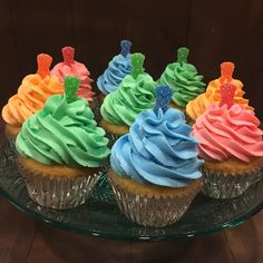 cupcakes with colorful frosting on a glass plate