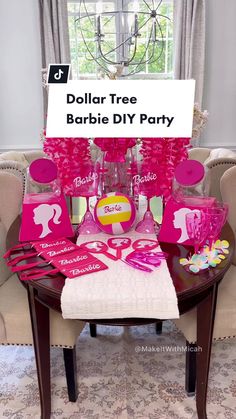 a barbie party table with pink decorations and decorating items on it, including a sign that says dollar tree barbie diy party