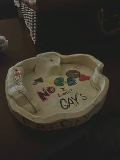 a bowl with writing on it sitting on a table