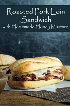 two sandwiches sitting on top of a wooden table