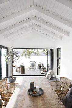 a wooden table sitting under a white ceiling