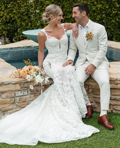 a bride and groom sitting next to each other in front of a pool at their wedding