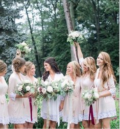 a group of women standing next to each other holding bouquets