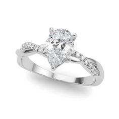 a pear shaped diamond engagement ring on a white background