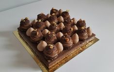 a cake with chocolate frosting and nuts on top