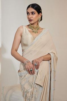 Eggshell pre-draped saree with pearl embroidery details in georgette base. Paired with a padded sleeveless blouse.
Components: 2
Pattern: Embroidered
Type Of Work: Pearl
Neckline: V Neck
Sleeve Type: Sleeveless
Fabric: Georgette, Net
Color: Beige
Other Details: 
Attached lining
Blouse length: 12.5 inches
Occasion: Mehendi and Haldi - Aza Fashions Elegant Pre-draped Georgette Saree With Mirror Work, Elegant Designer Pre-draped Saree With Mirror Work, Elegant Pre-draped Saree With Mirror Work For Designer Wear, Elegant Mirror Work Pre-draped Saree For Diwali, Elegant Pre-draped Saree With Mirror Work For Diwali, Elegant Draped Cutdana Blouse Piece, Elegant Draped Blouse Piece With Cutdana, Elegant Sleeveless Designer Wear Blouse Piece, Elegant Sleeveless Designer Blouse Piece