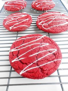 red velvet cookies with white icing on a cooling rack