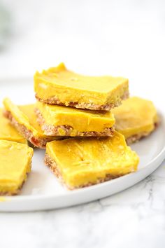 several pieces of yellow dessert on a white plate