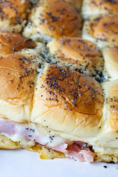 a ham and cheese slider cut in half on top of a white platter