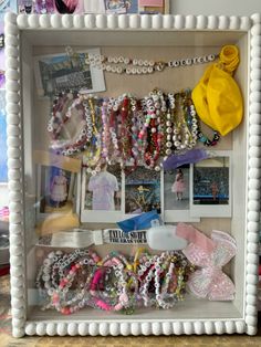 a display case filled with lots of different types of bracelets and necklaces on it