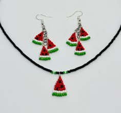 a necklace and earring made out of beads with watermelon slices on them